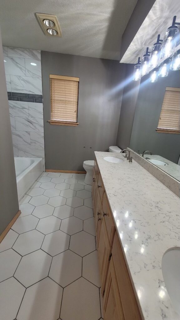 Refinished countertops on vanity across from tub-to-shower conversion.