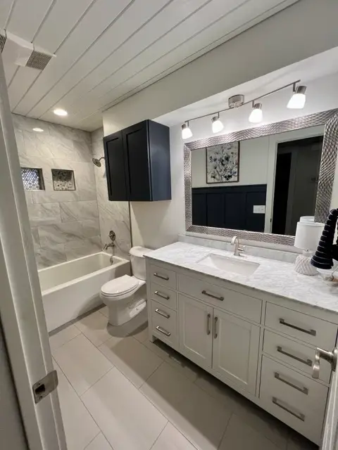 Elegant marble-look tile shower and soaker tub remodel by Justus Bath in Edmond, Oklahoma
