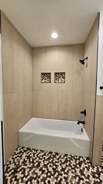 Sleek beige-tile bathtub and shower remodel by Justus Bath in Edmond, Oklahoma