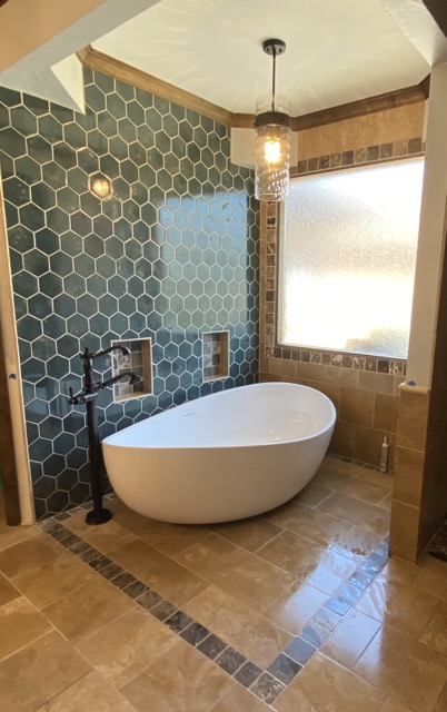 A gorgeous bathroom remodel with green and copper accents.