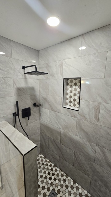 Clean Shower Remodel with Black and White Design and Accents